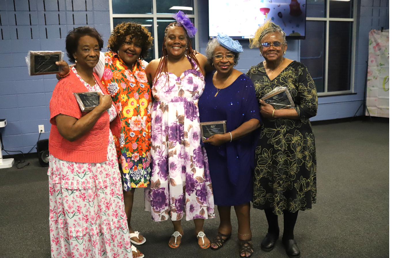 Five women holding recognition plaques at a Smart Start retiree appreciation event